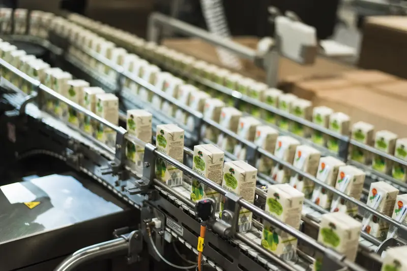 Production line of beverage cartons in a food and beverage manufacturing facility, highlighting efficient processing and packaging.