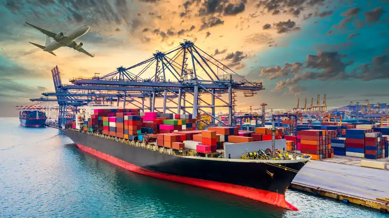 Cargo ship loaded with colorful containers at a busy port, with cranes and an airplane overhead, symbolizing logistics and transport sectors in international business.